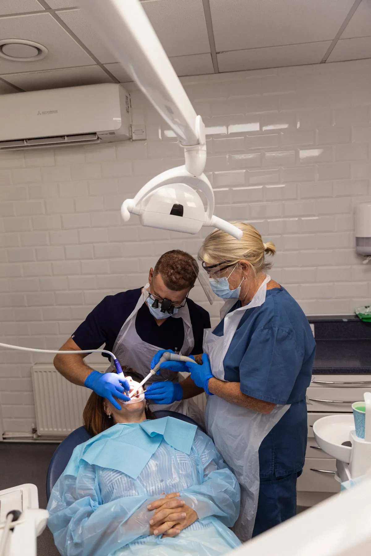 Two Charles Street Dental Surgery clinicians working together on a patient